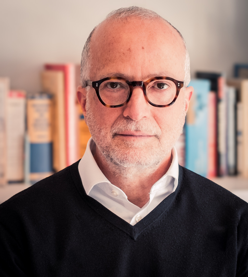 Author profile picture of Charles Hecker, looking straight at the camera weighing glasses