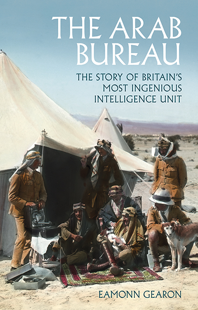 Book cover for THE ARAB BUREAU showing a tent in the desert with spies in WWI gathered around an woven rug and a smoking pipe and a dog.