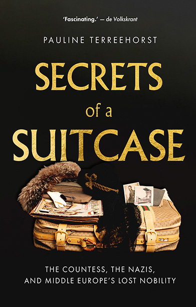 Book cover for SECRETS OF A SUITCASE that shows a historic Gucci suitcase open with a fur and personal belongings visible and writing in gold with black background.