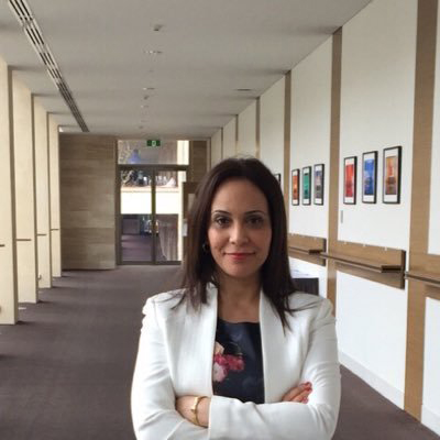 Author profile pic of Leila Ben Mcharek staring into camera with arms folded across chest.