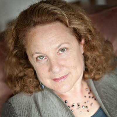 Headshot of author Carla Kaplan looking directly into the camera and smiling.